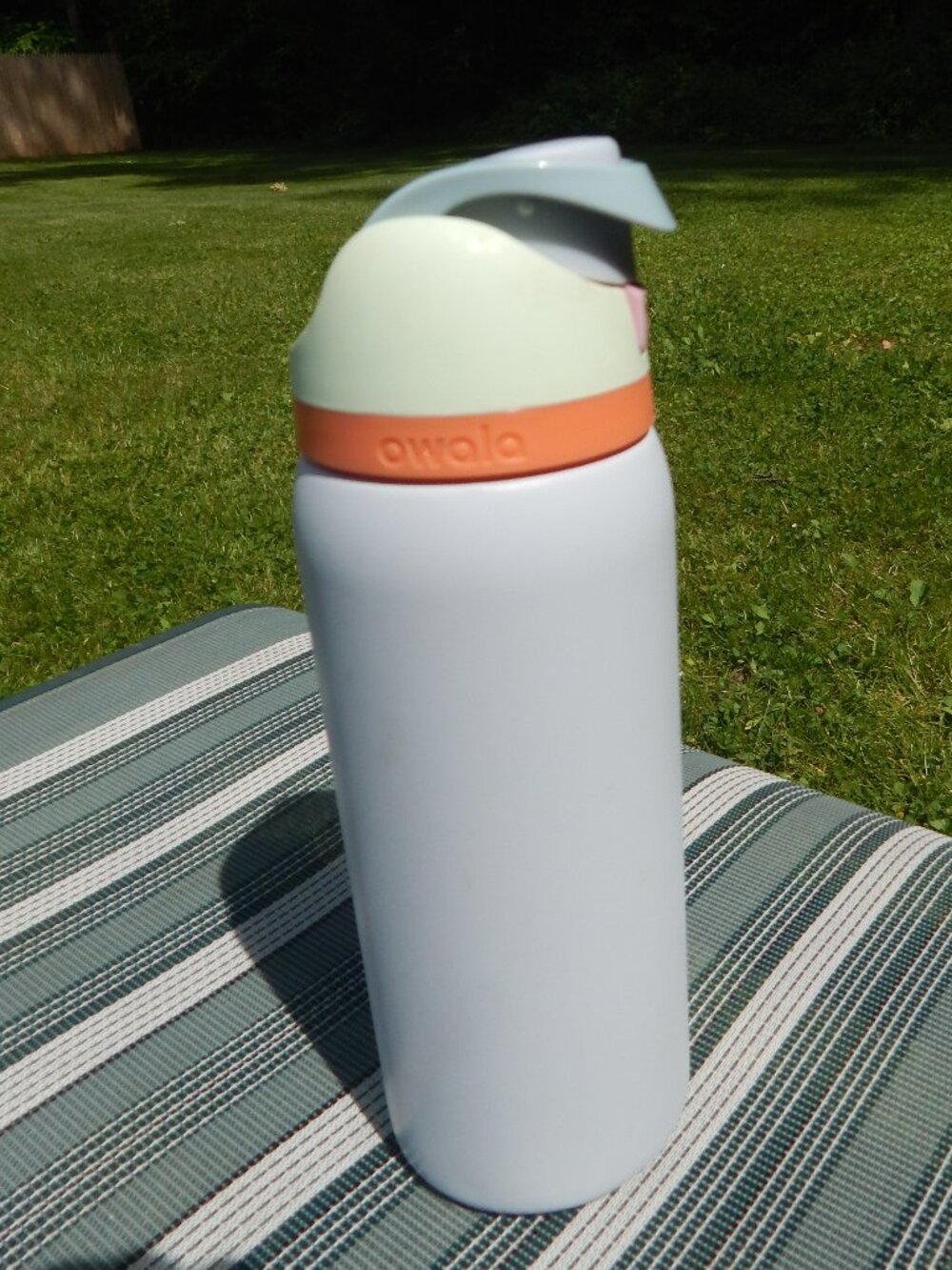 Owala water bottle, grey, orange, yellow and pink.